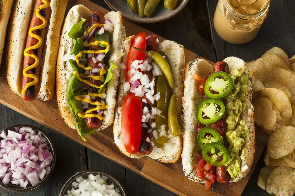 Gourmet grilled all beef hot dogs with sides and chips.
