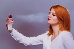 Woman using setting spray.