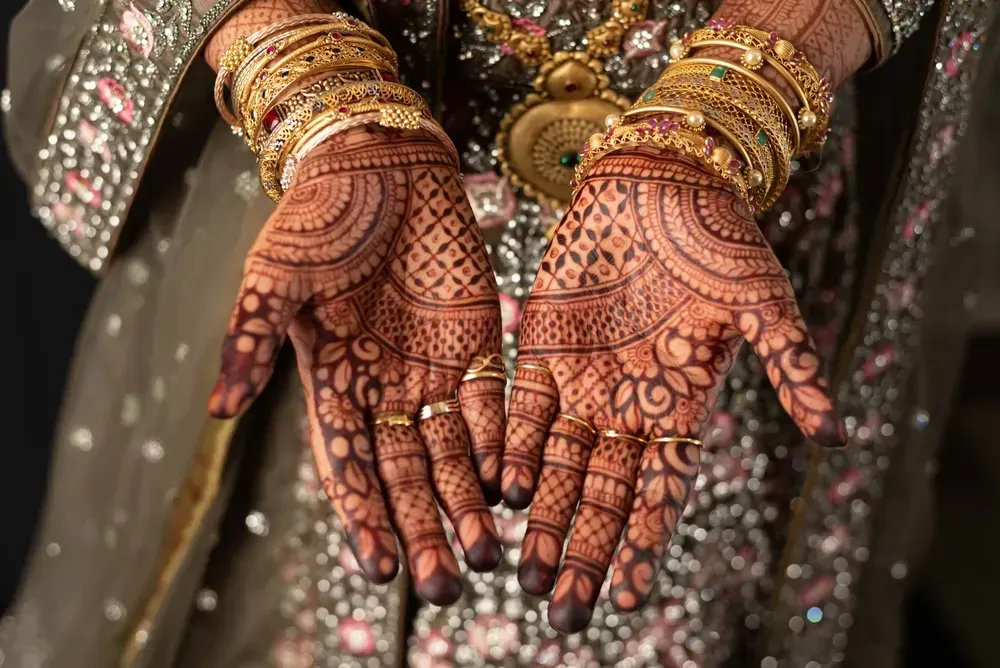 Hands of  bride with henna Mehandi designs. 