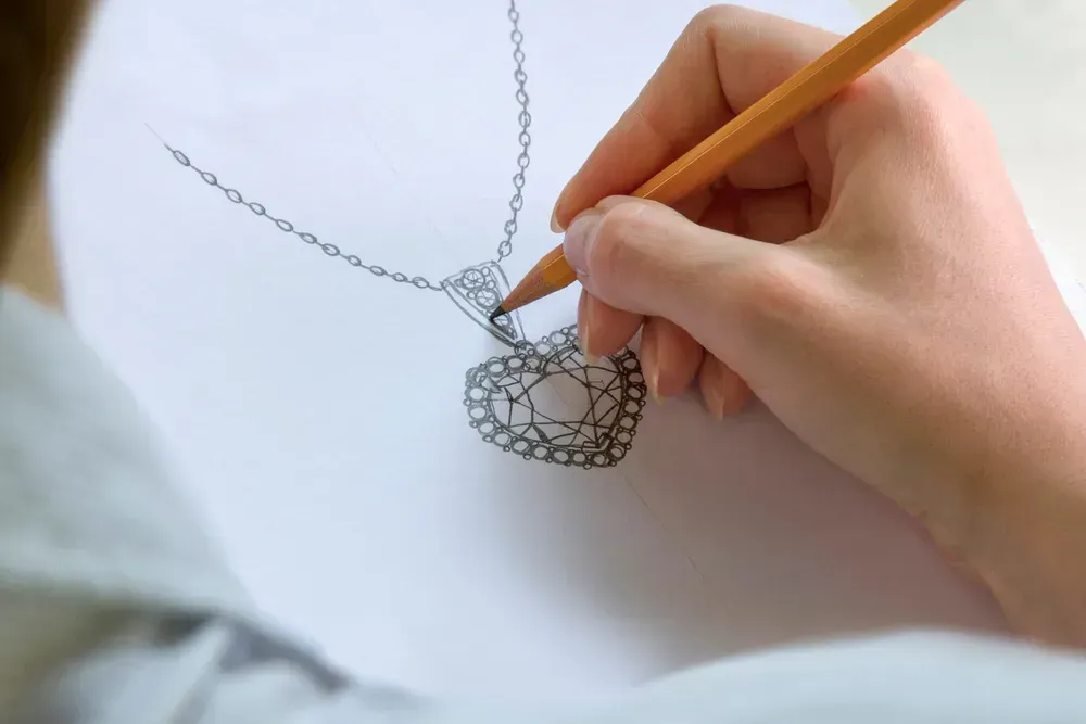 Jewelry designer sketching pendant concept. 