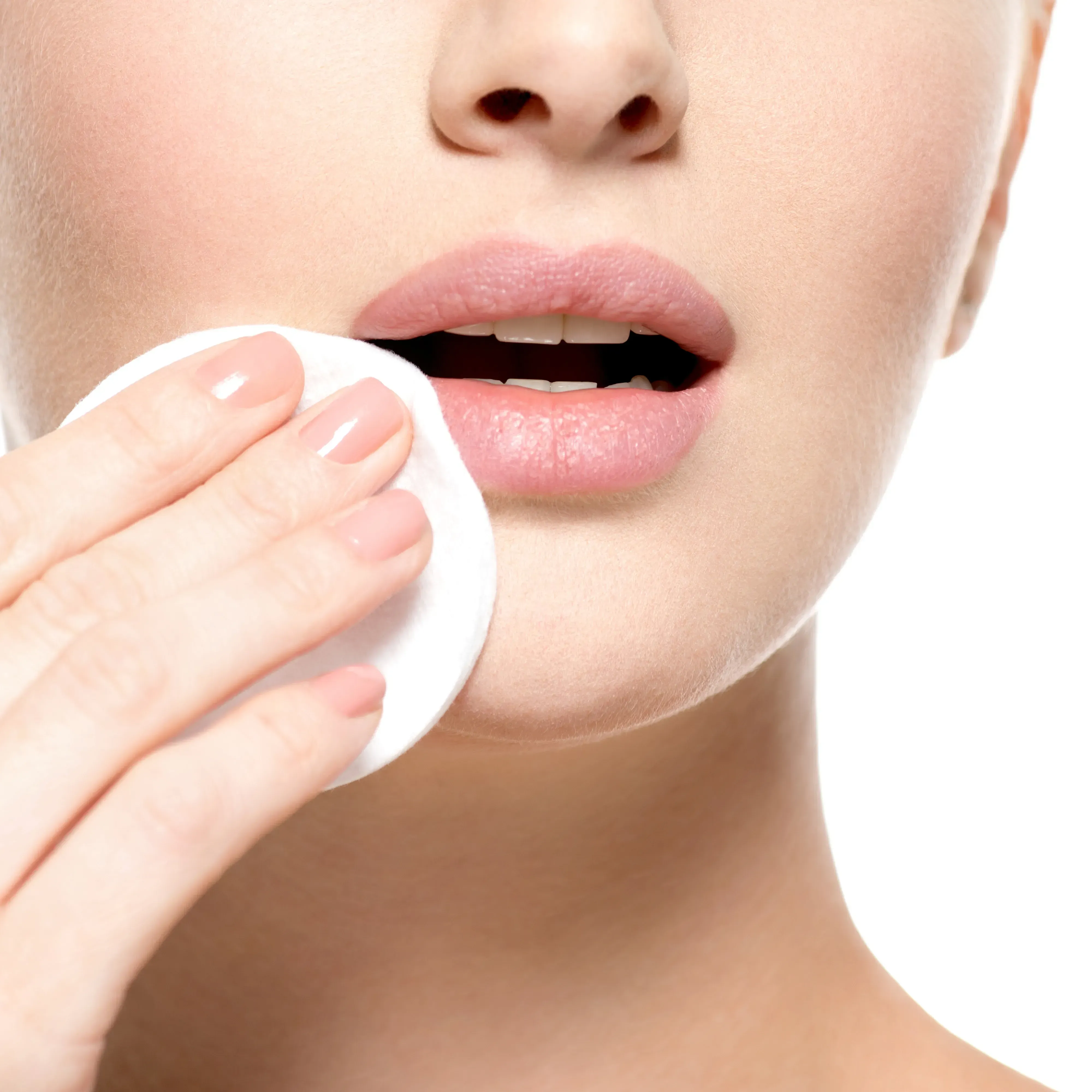 Woman removing make up using a cotton ball. 