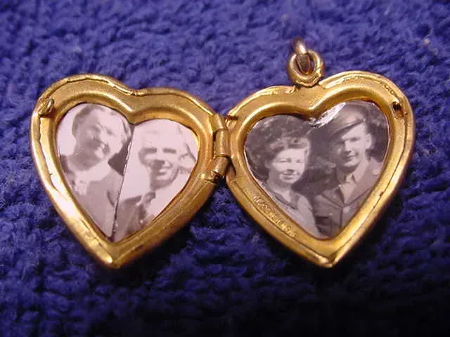 Small heart locket with picture of a young and old couple.