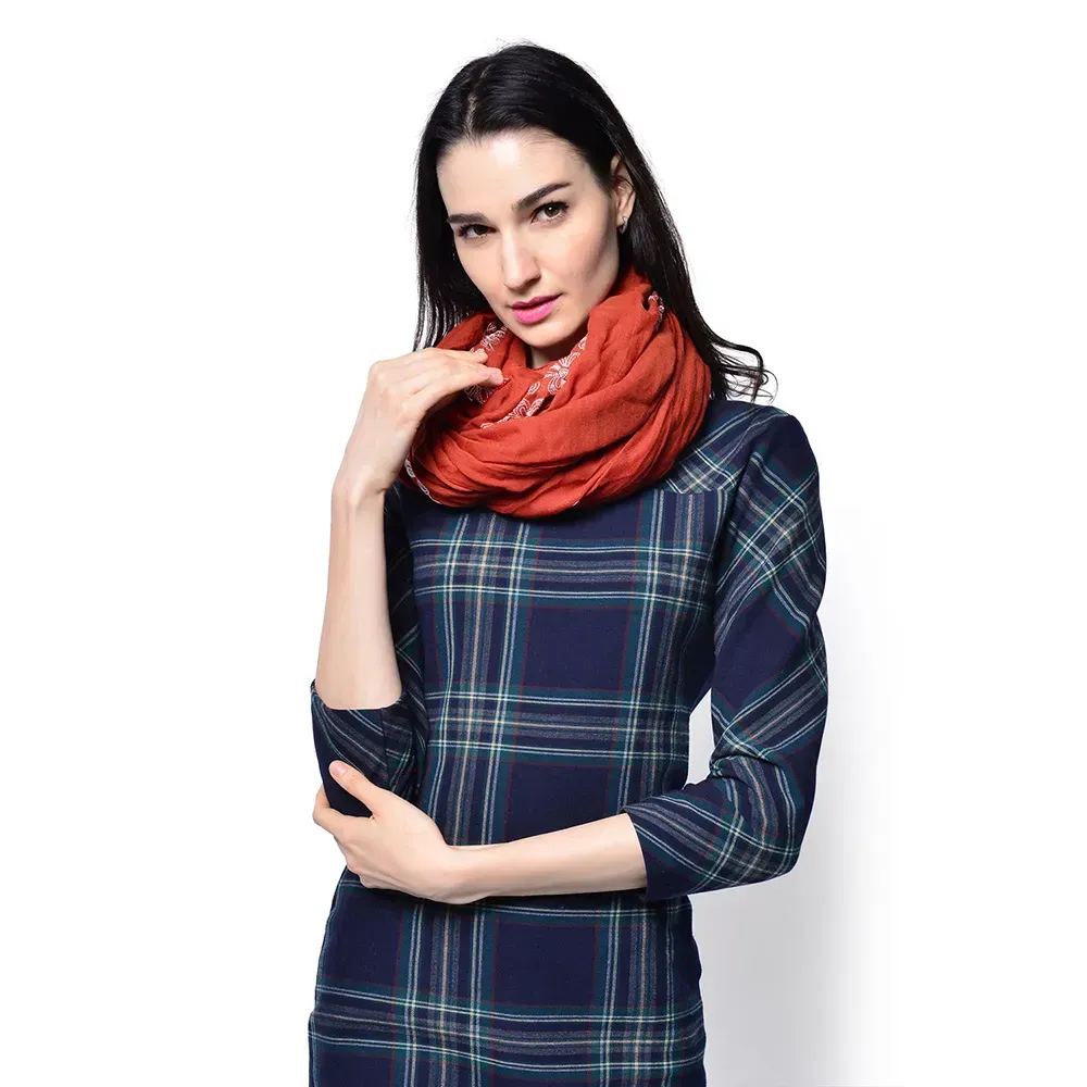 Woman wearing a red scarf against white background
