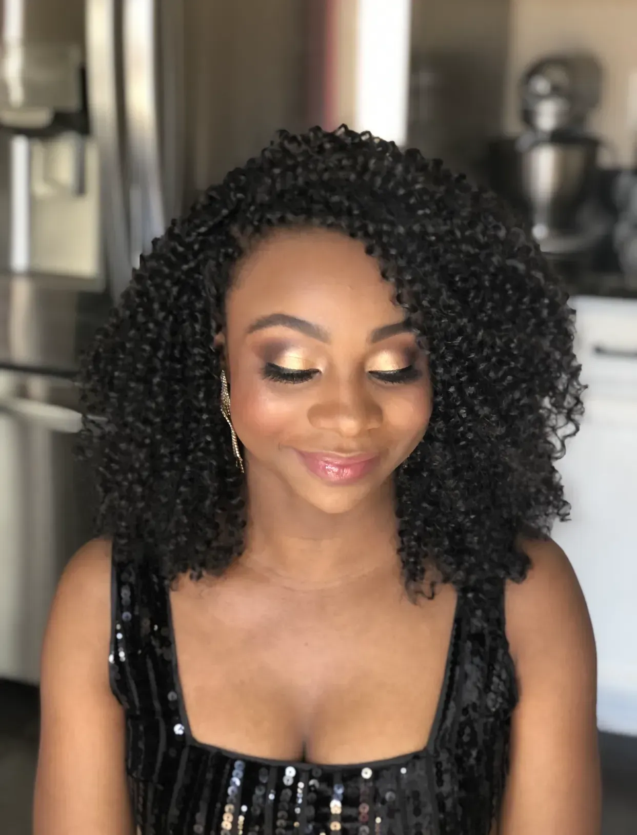Black woman showing off metallic inspired makeup trend.