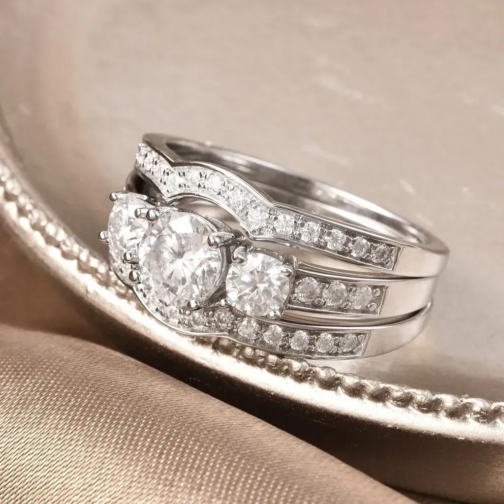 Moissanite 3 stone ring with enhancers.