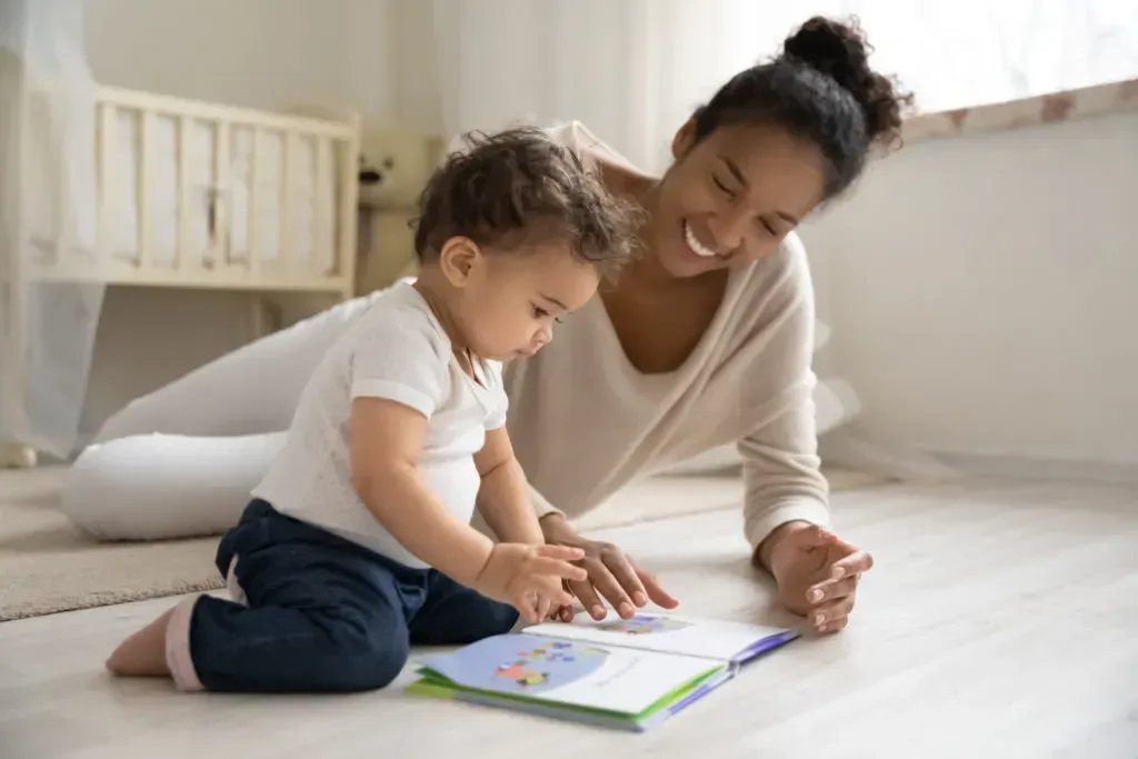 Mother and son reading in playroom.
