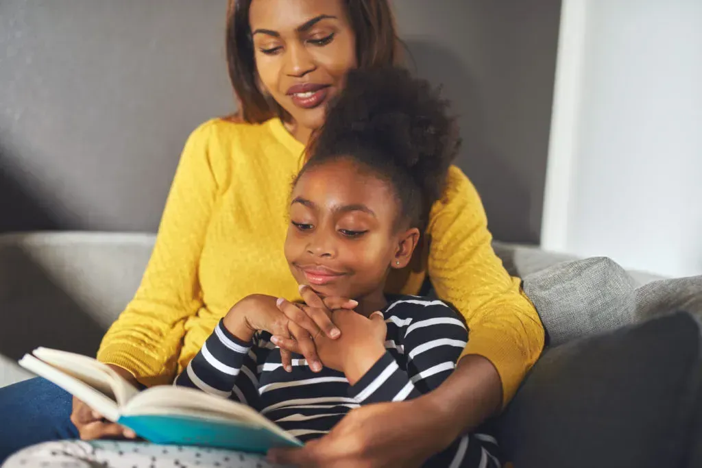 Mother reading with daughter.