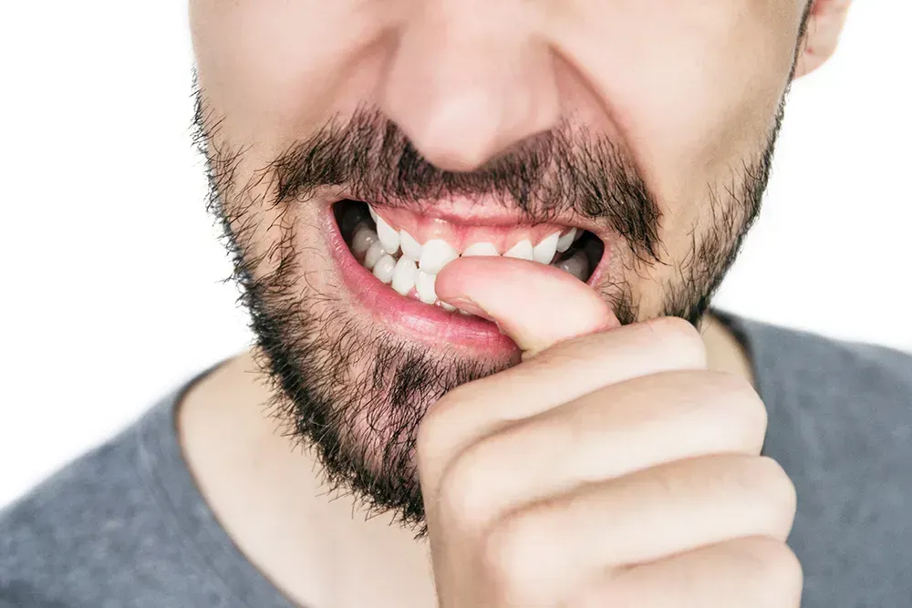 Man biting his nails.
