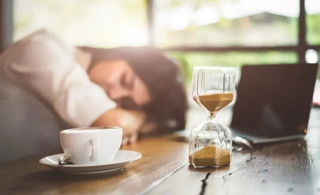 Woman napping at her desk during work.