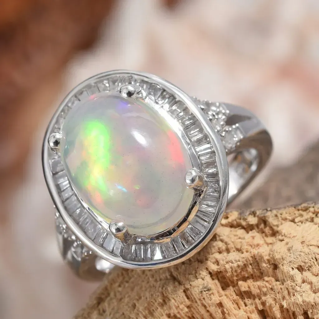 Welo opal halo ring in sterling silver on natural display.