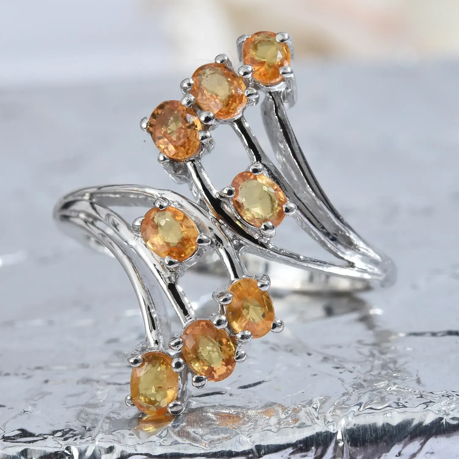Orange sapphire bypass ring in sterling silver. 