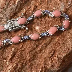 Oregon peach opal bracelet resting on red rock.
