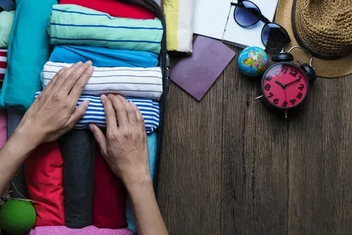 rolling clothes in luggage