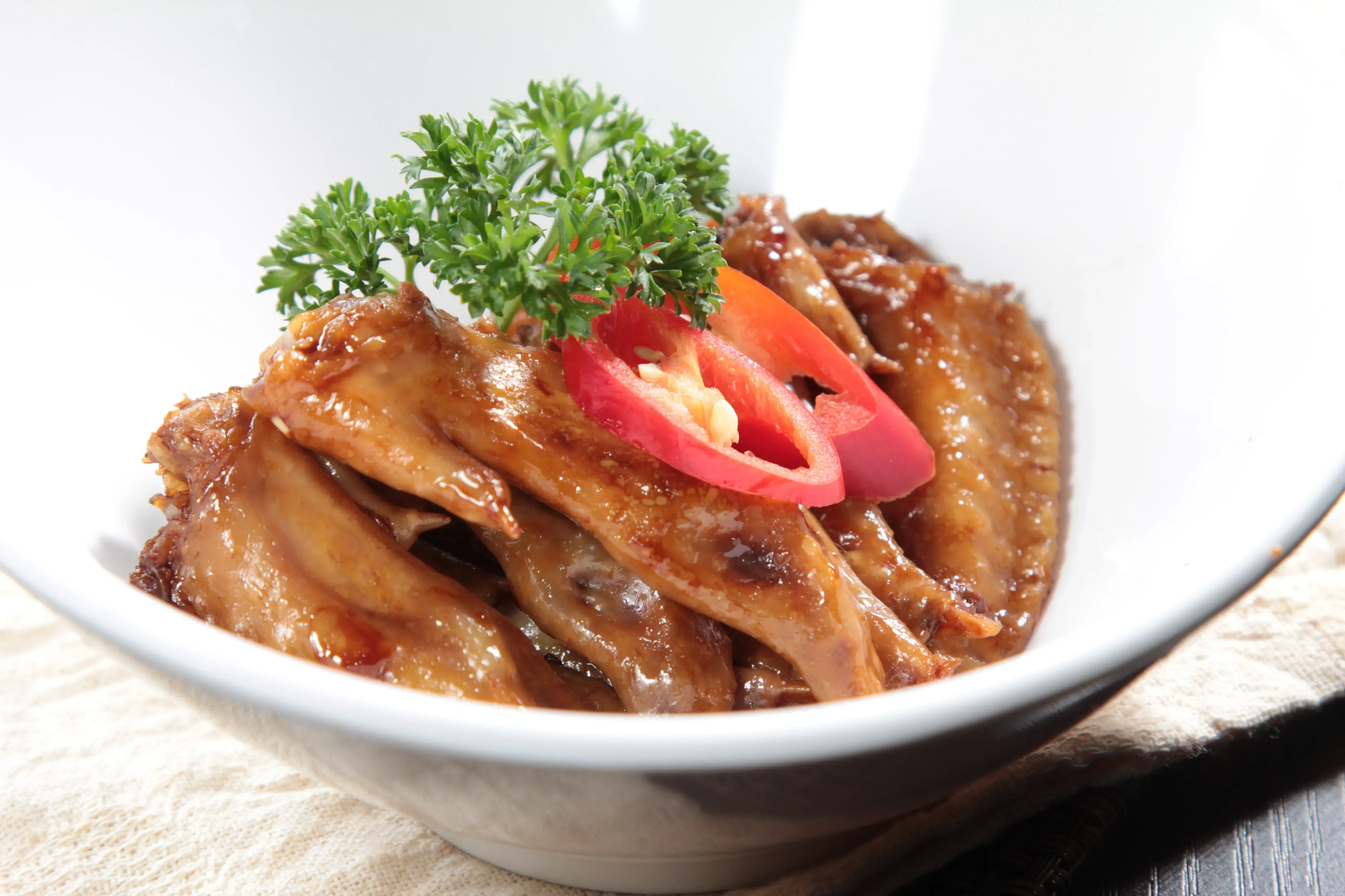 Dish of braised chicken with garnish.