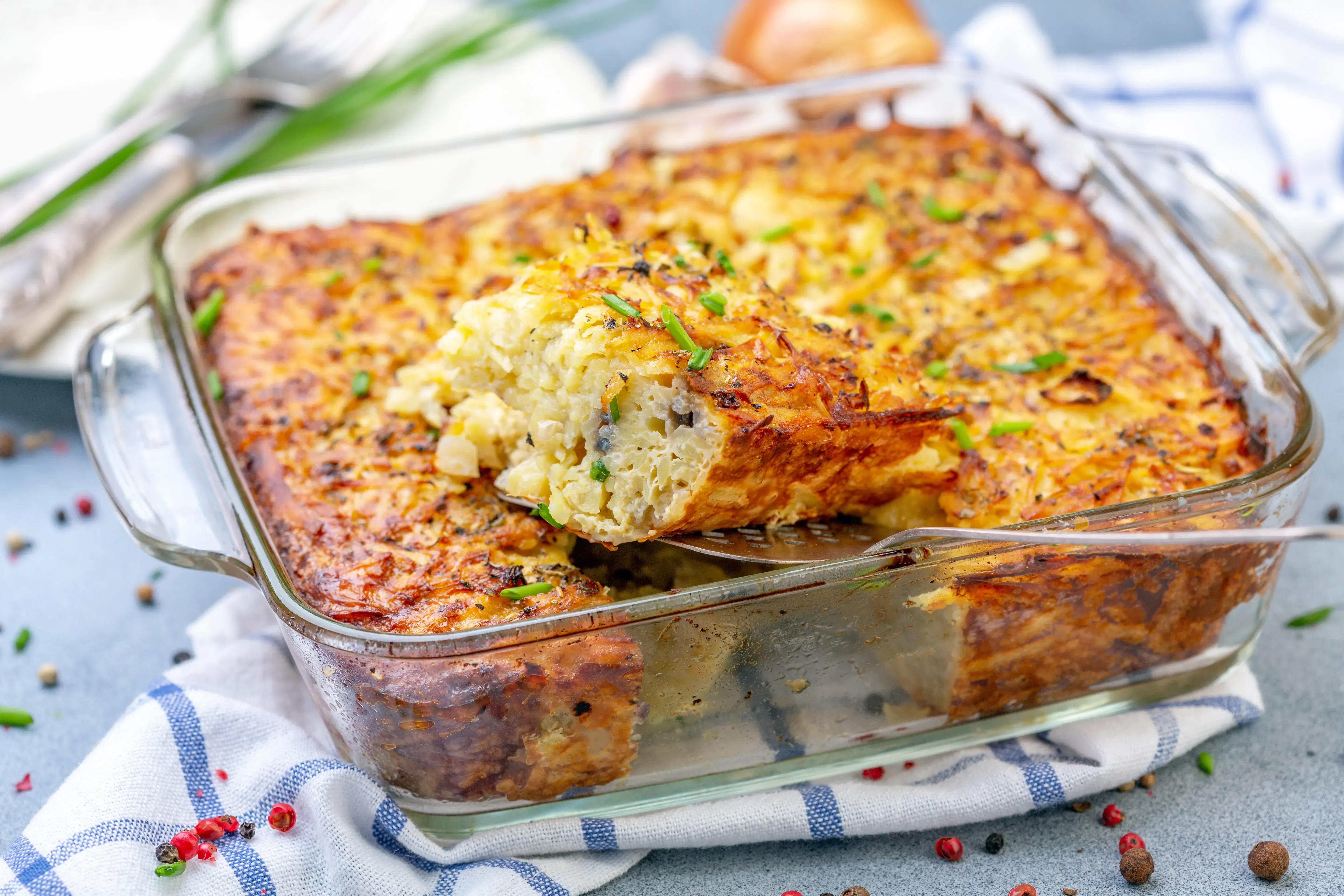 Potato kugel being served from tray.