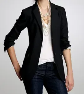 Woman wearing pearl and bead necklaces.