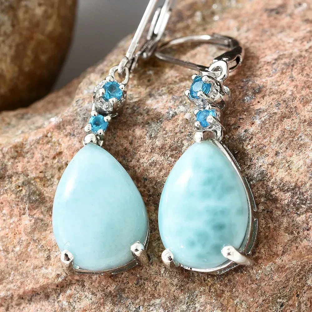 Closeup of peridot earrings against