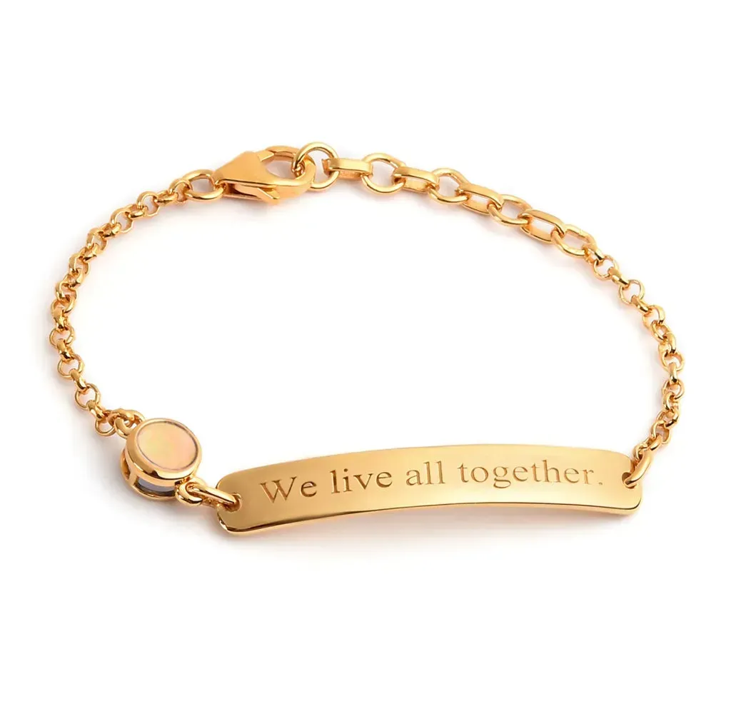 Gold bracelet with inscribed motto.