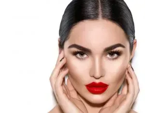 Woman with minimalistic makeup and bright red lipstick.