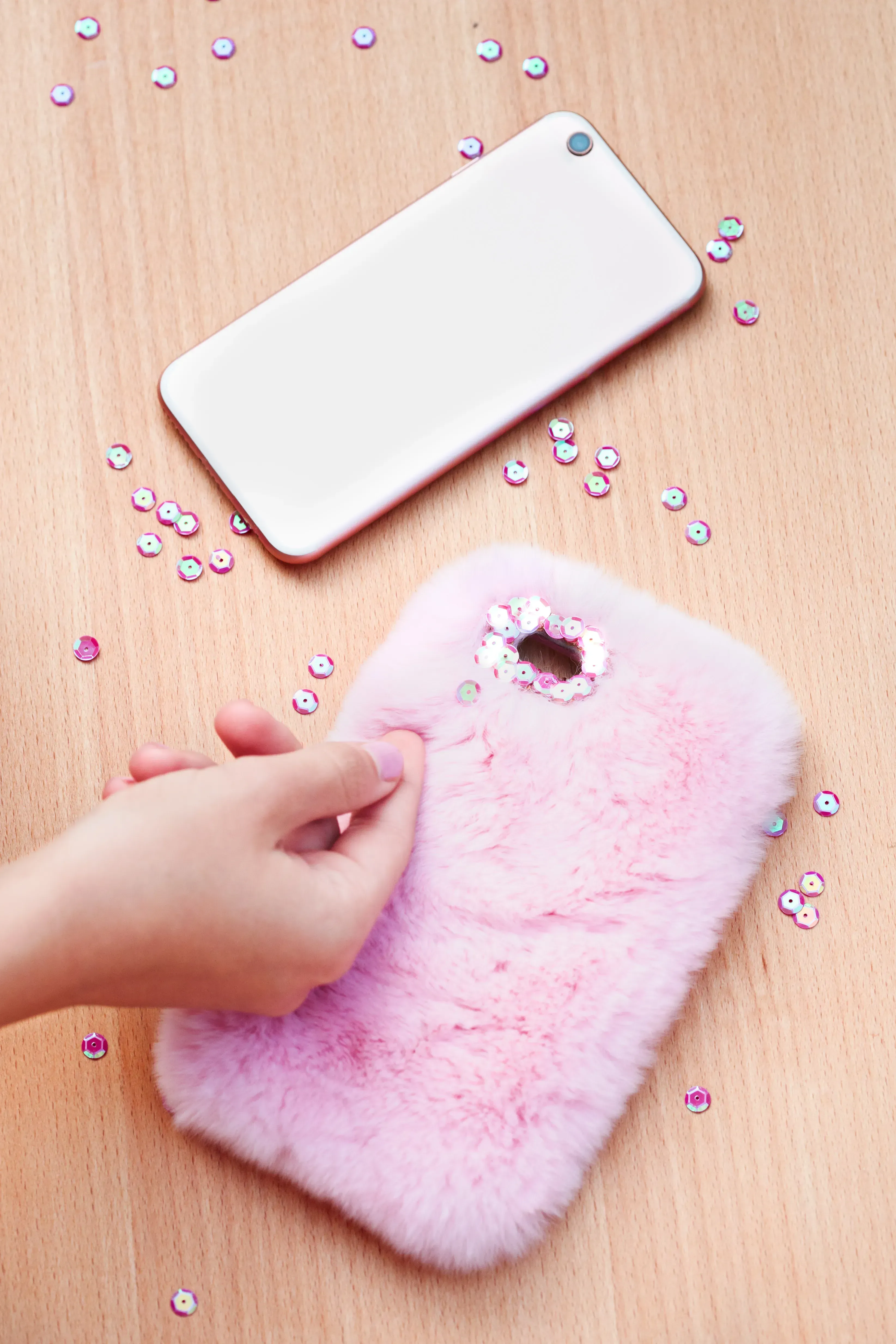 Making a phone case from upcycled jewelry materials. 