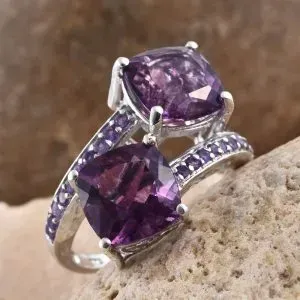 Purple fluorite bypass ring with amethyst accents in sterling silver.