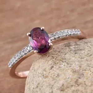 Purple garnet solitaire ring in sterling silver with 14k yellow gold finish. 