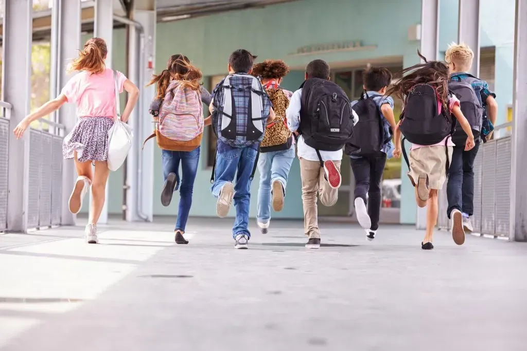 School age kids running to class.