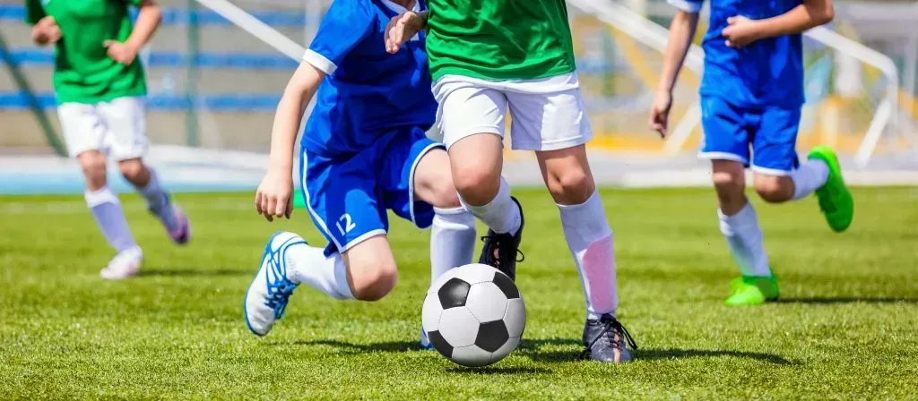 Children playing soccer. 