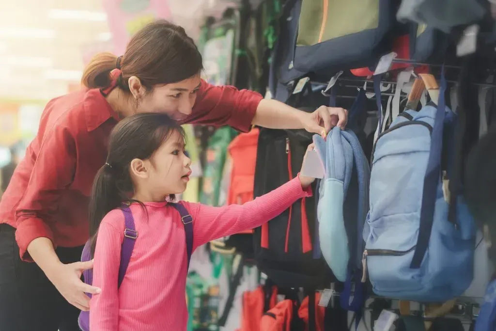 Mother and daughter shopping for a backpack.