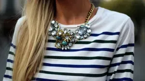 Large statement necklace worn with conservative neckline.