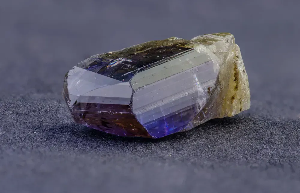 Tanzanite crystal on black background.