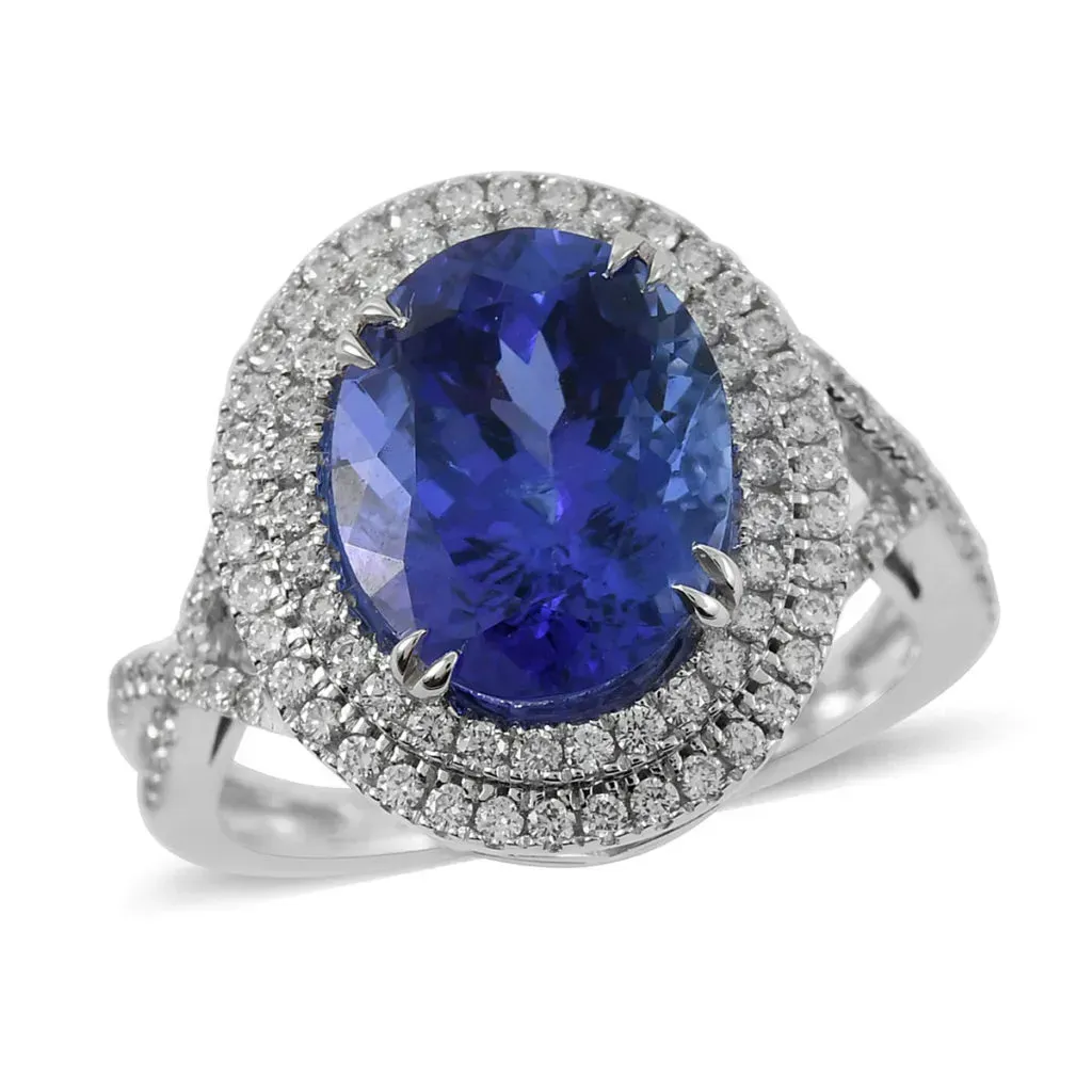 Blue gemstone ring with double diamond halo in white gold. 