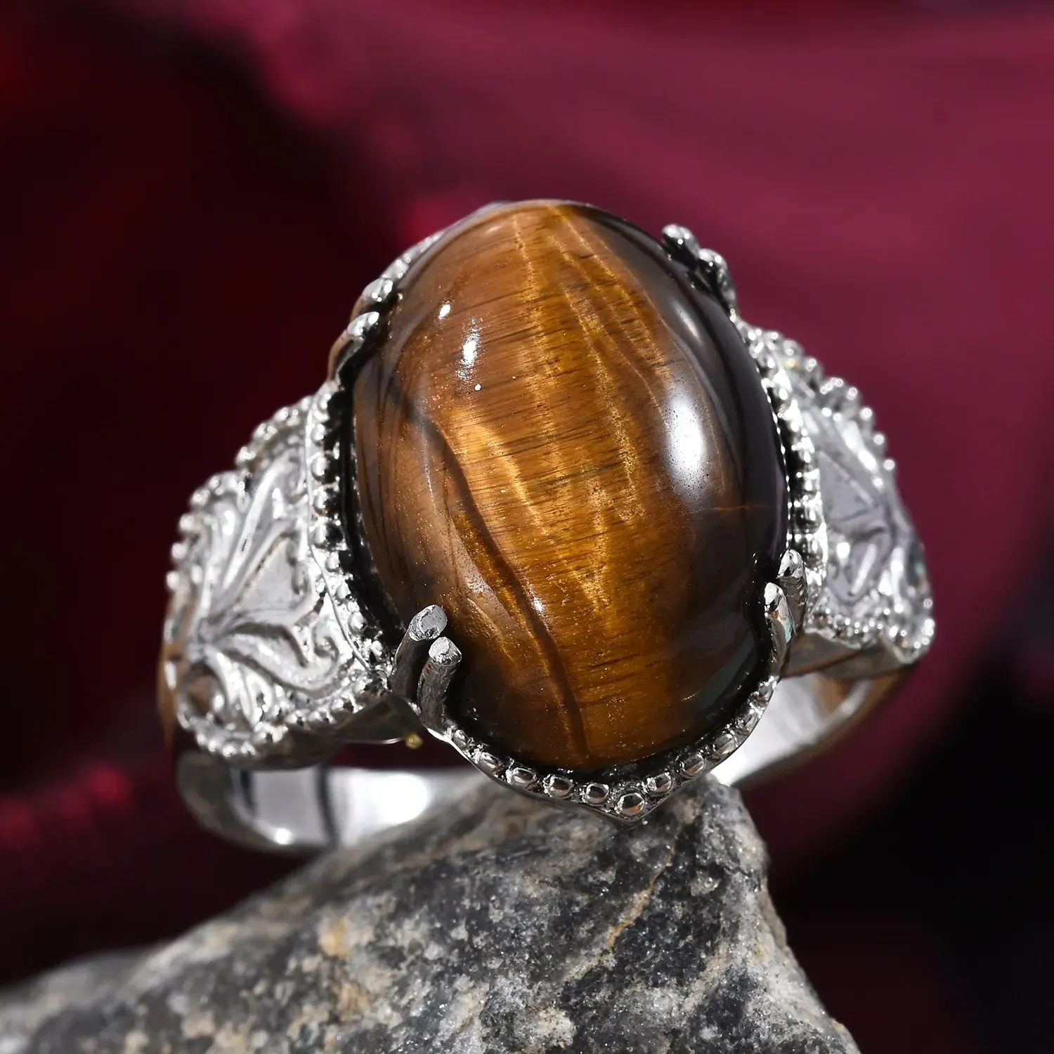 Silver ring featuring prominent tiger's eye gemstone.