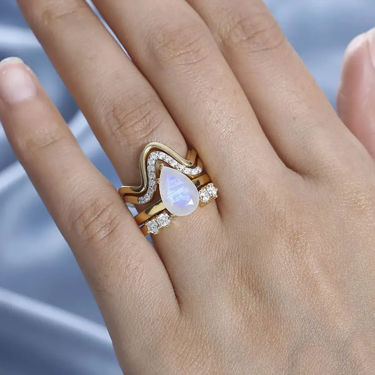 Rainbow Moonstone and Moissanite Set of 4 Stackable Ring in Vermeil Yellow Gold Over Sterling Silver Rainbow Moonstone and Moissanite Set of 4 Stackable Ring in Vermeil Yellow Gold Over Sterling Silver worn on woman's hand.