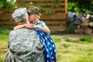 Child greeting military parent.
