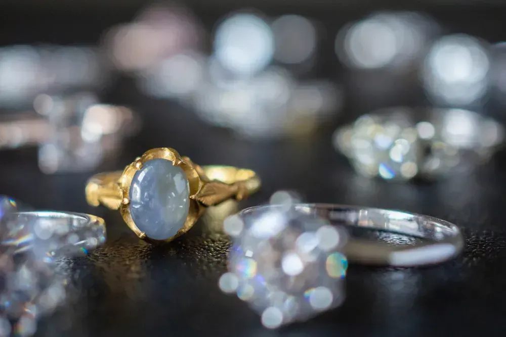 Selection of gemstone rings on dark background. 