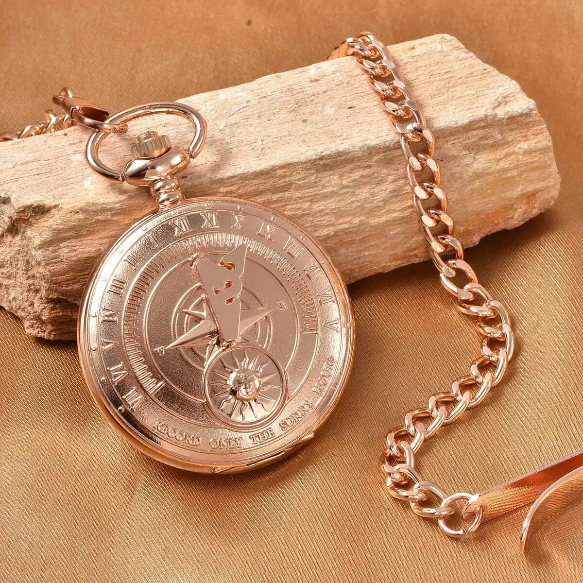 Strada Japanese Movement Compass Pattern Pocket Watch in Rosetone With Chain (14-18 Inches) (47.24 mm) on wood and cloth background.