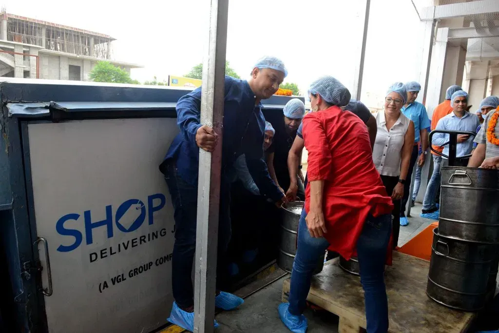 Shop LC employees helping load a truck with healthy meals!