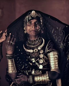 Tribal Indian person wearing traditional garb and jewelry. 